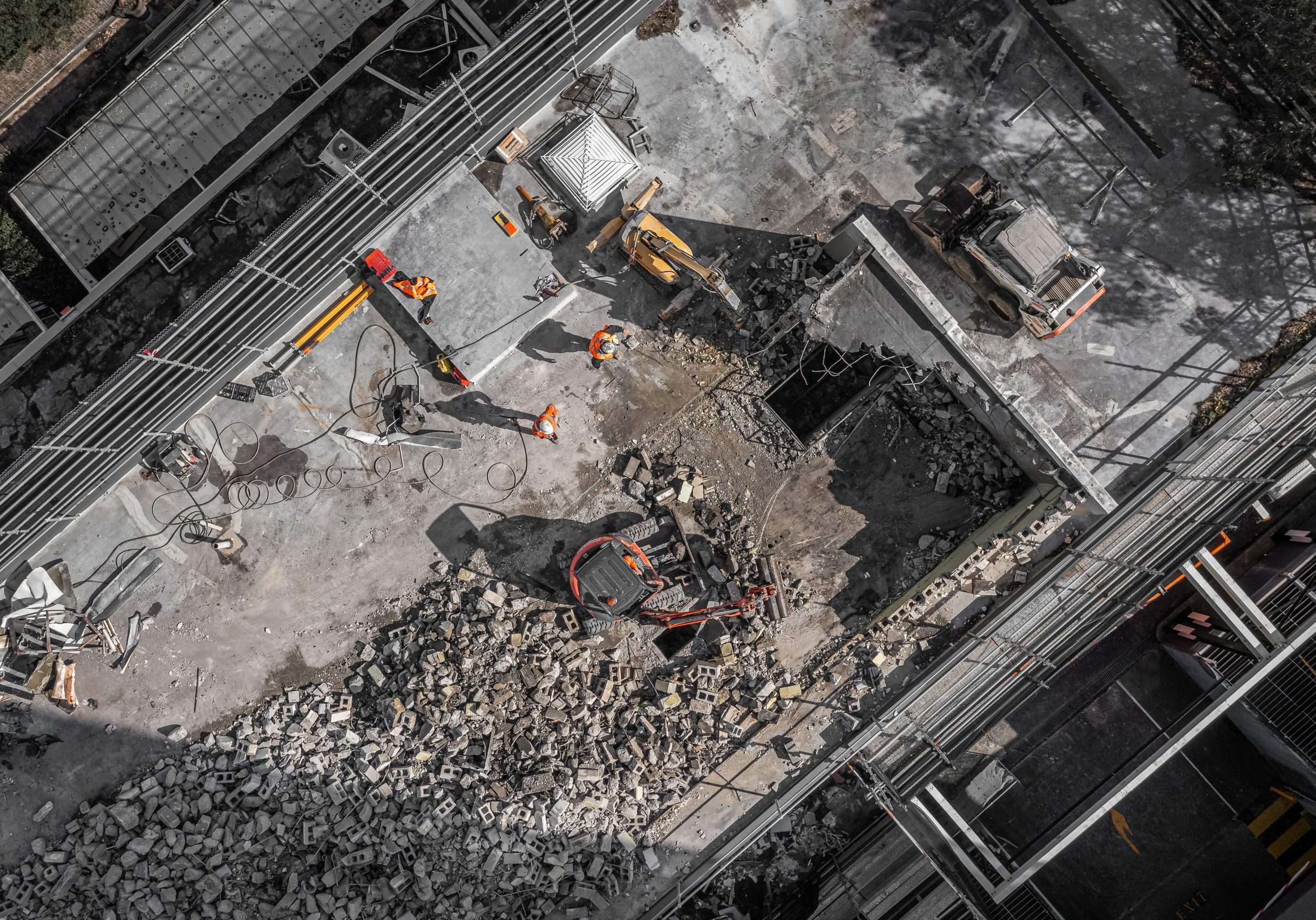 Aerial drone photo of demolition site and construction workers